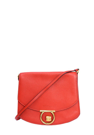 Authentic Salvatore Ferragamo Gancini medium red pebbled leather crossbody bag with gold-tone Gancini clasp and adjustable shoulder strap.