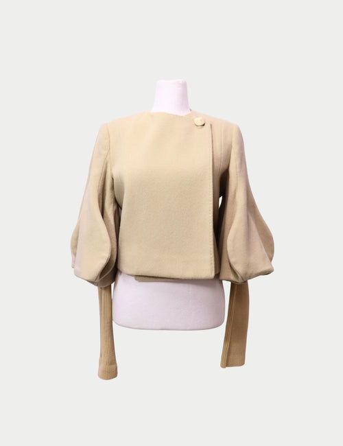 Stella McCartney beige wool top with voluminous puff sleeves, asymmetrical front panel, and ribbed elongated cuffs
