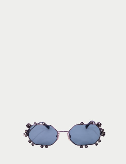 Blue-tinted Swarovski sunglasses with octagon lenses and crystal rhinestone embellishments around the frame