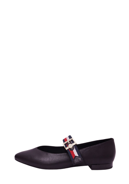 Tommy Hilfiger black leather Mary Jane flats with signature red, white, and navy webbing strap, gold-tone buckle, and pointed toe