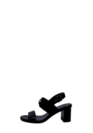 Tory Burch black leather sandals featuring a block heel, adjustable ankle strap, and minimalist open-toe design