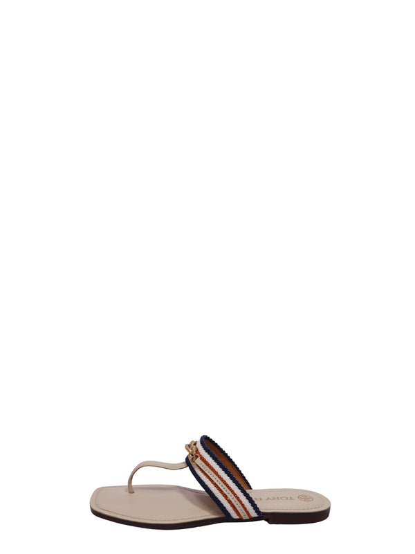 Tory Burch flat thong sandals with orange and navy striped woven straps and gold-tone chain detail on a cream leather footbed.