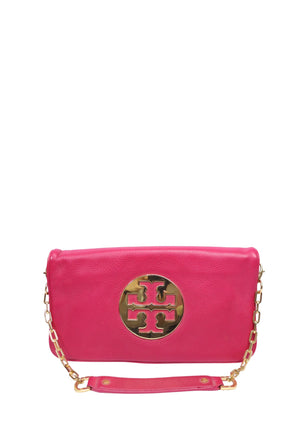 Tory Burch Reva bright pink pebbled leather clutch crossbody bag with gold-tone logo plaque and chain shoulder strap.