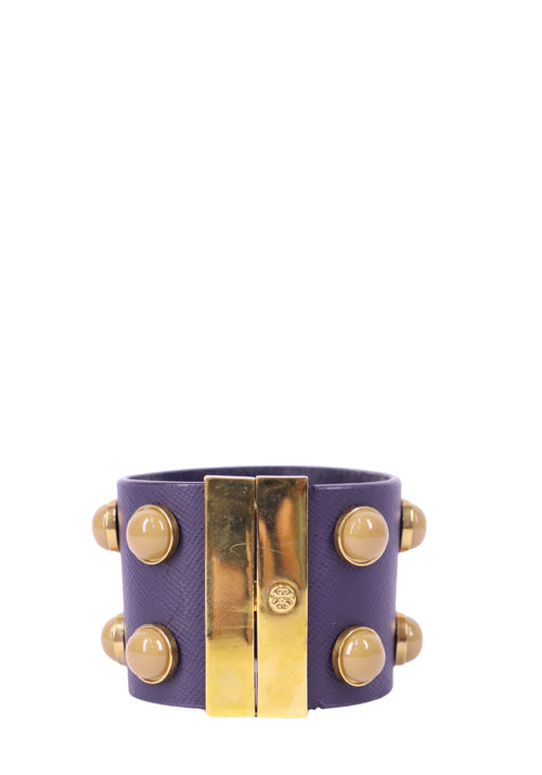 Tory Burch purple leather cuff bracelet with gold-tone hardware and rounded embellishment details.