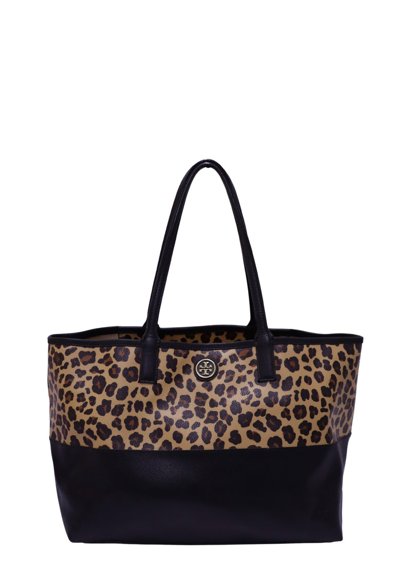 Tory Burch leopard print tote bag featuring a beige and black animal print canvas upper, black leather base and shoulder straps, gold-tone Tory Burch logo medallion, open-top design, and a spacious structured silhouette