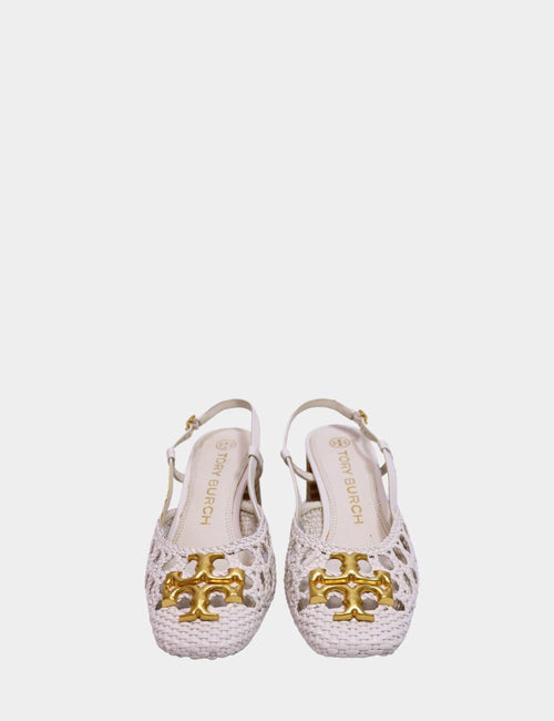 "Tory Burch woven ivory slingback heels with gold logo hardware and cut-out upper, displayed on white background."

