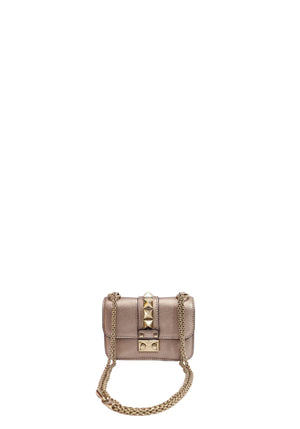 Valentino Garavani metallic rose gold mini crossbody bag with Rockstud embellishments, gold-tone chain strap, and flap-front push-lock closure.