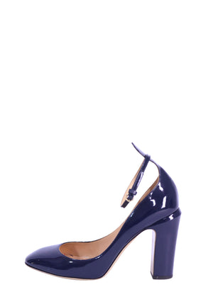 Valentino navy patent leather pumps featuring a glossy finish, round toe, adjustable ankle strap, and chunky block heel