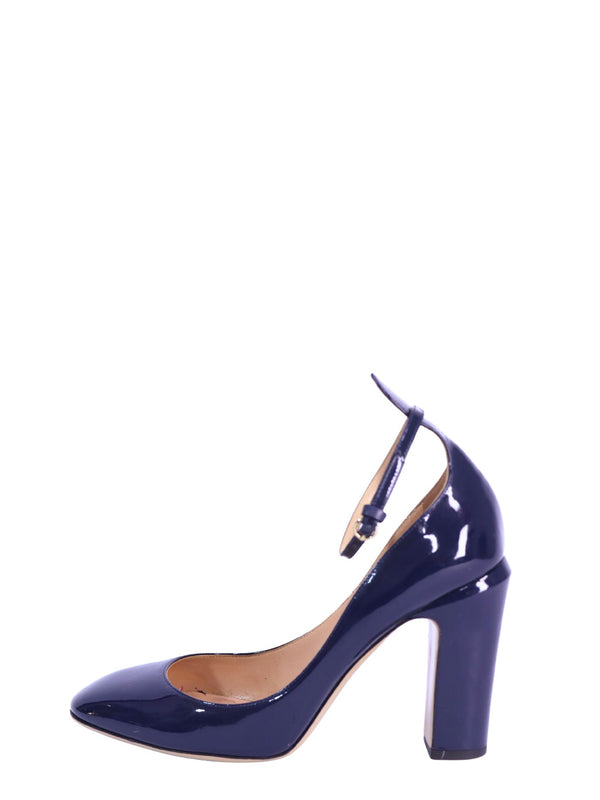 Valentino navy patent leather pumps featuring a glossy finish, round toe, adjustable ankle strap, and chunky block heel