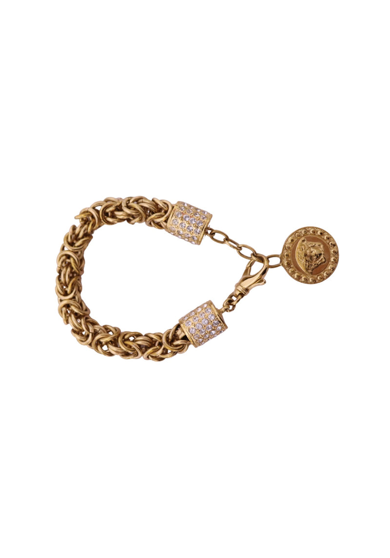 Versace gold-tone chunky chain bracelet featuring intricately interwoven links, two crystal pavé-embellished cylindrical accents, an oval Medusa-style charm and lobster clasp