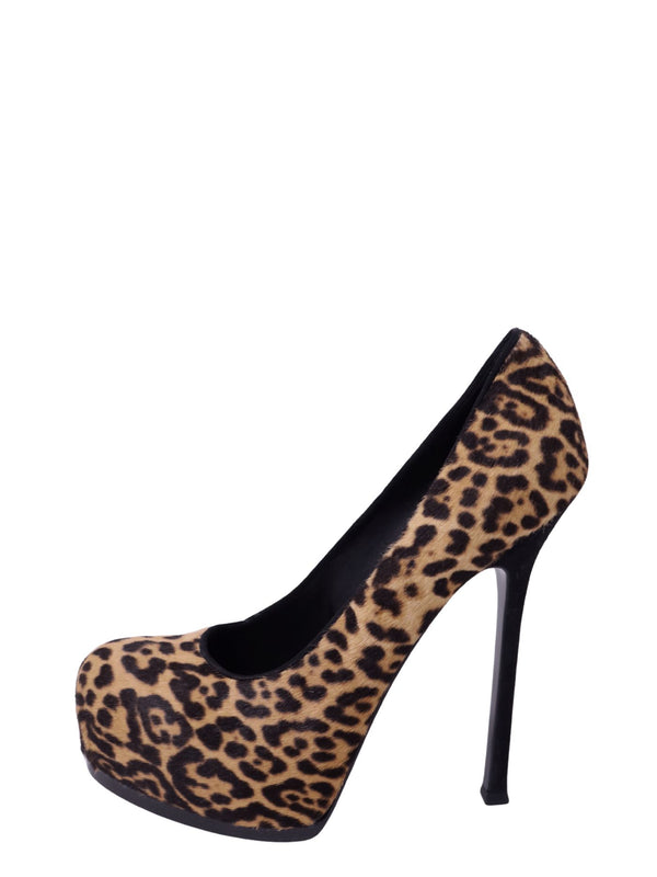 Pair of Saint Laurent leopard-print platform pumps featuring camel and black animal-print textured uppers, rounded almond toes, high covered platforms, and slender black stiletto heels