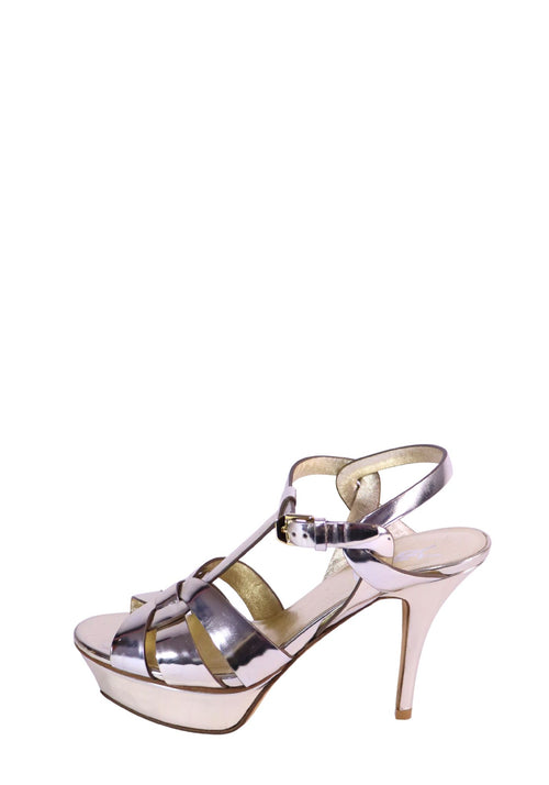 Saint Laurent silver metallic platform sandals with crossover straps and high stiletto heels.