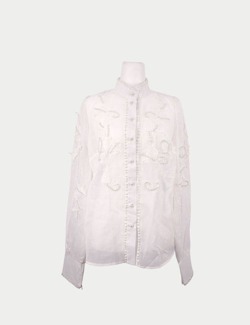 Zimmermann white sheer blouse with embroidered detailing, pearl embellishments, long sleeves, and front button closure