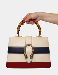 Gucci Dionysus tricolor leather bag with bamboo top handle and signature Dionysus tiger-head clasp.


