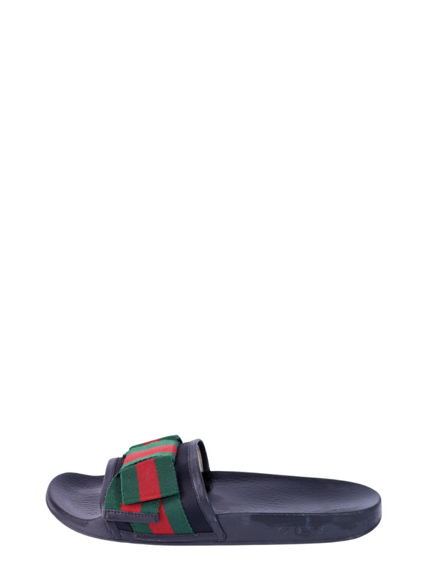Gucci black slide sandals featuring the signature green and red web stripe strap and molded footbed.