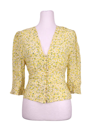 Authentic Rixo yellow floral blouse with white daisy print, deep V-neckline, button front detailing, and smocked sleeve cuffs.