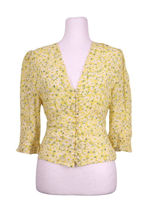 Authentic Rixo yellow floral blouse with white daisy print, deep V-neckline, button front detailing, and smocked sleeve cuffs.