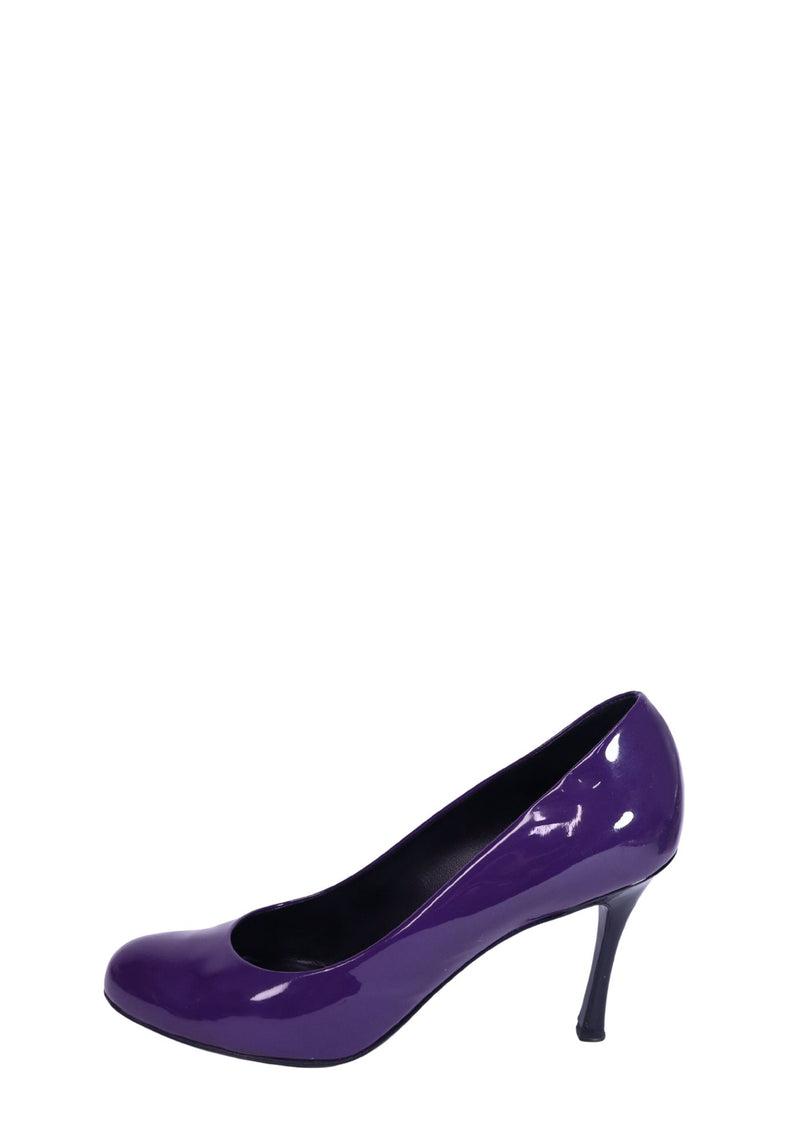 Saint Laurent purple patent leather pumps with round toe silhouette, glossy finish, and elegant curved mid-height heels.