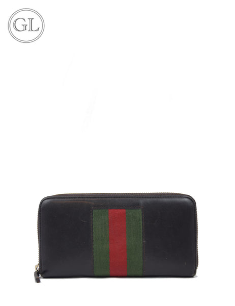 Gucci black leather zip-around wallet with green and red Web stripe.


